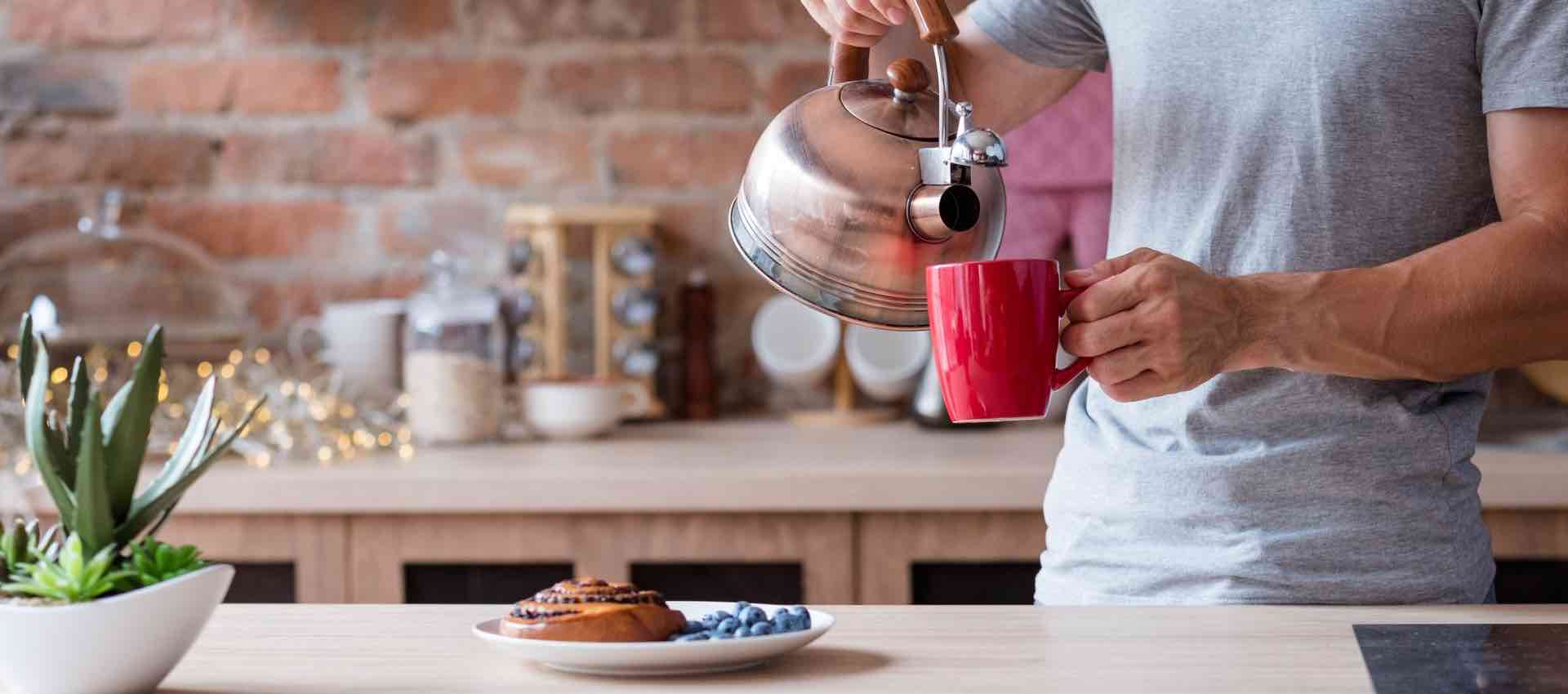 Man using boiled water to his coffee